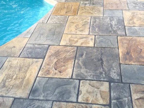 Close view of slip resistant flagstone stamped texture on a pool deck