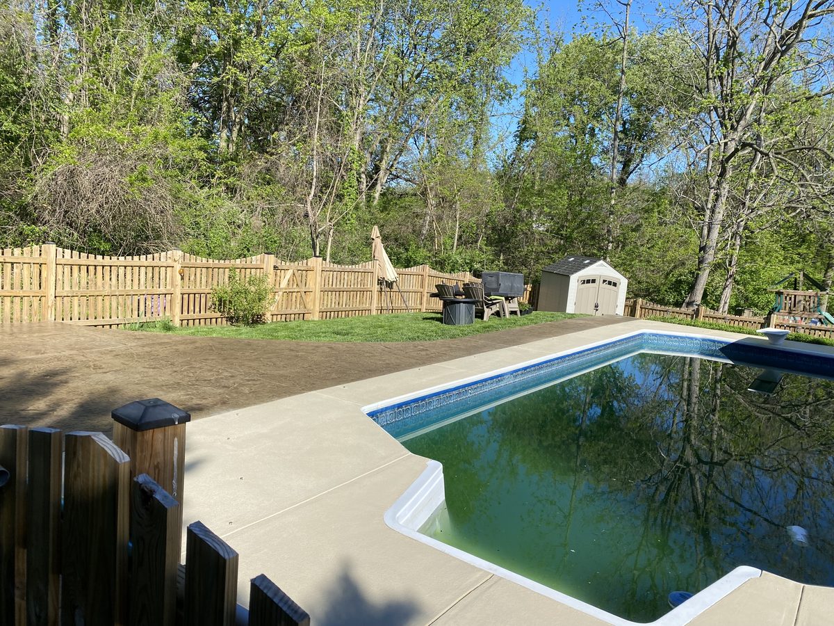 Stamped concrete pool deck in an ashlar slate pattern wrapping a freeform pool, Winchester VA