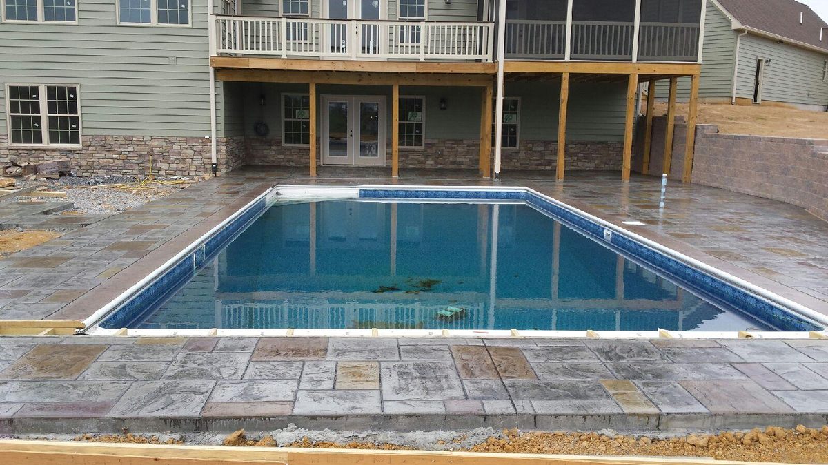Stamped concrete pool deck around a rectangular backyard pool, Winchester VA