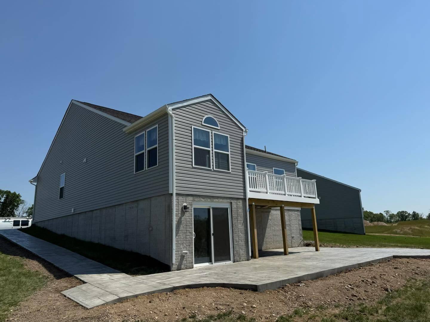 New concrete patio behind a gray sided home in Winchester VA