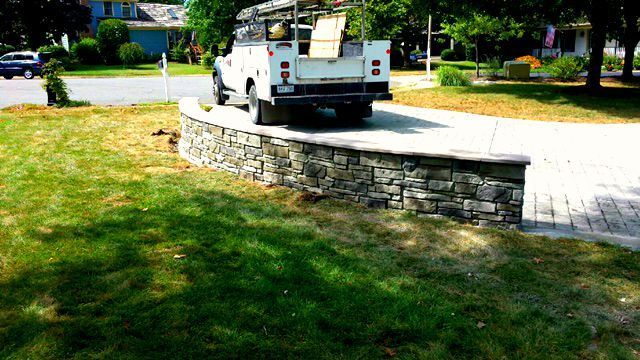 Concrete driveway with a decorative stone knee wall in Winchester VA