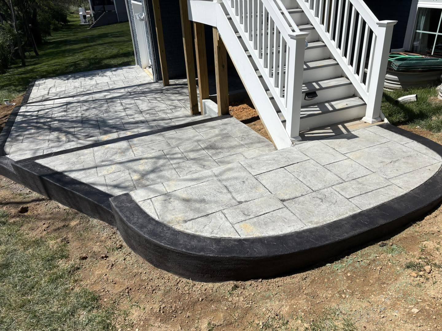 Large ashlar slate stamped concrete patio with a curved border in Winchester VA