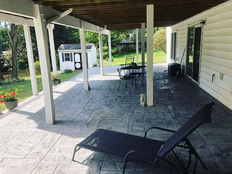 Covered concrete patio with lounge chairs in Winchester VA