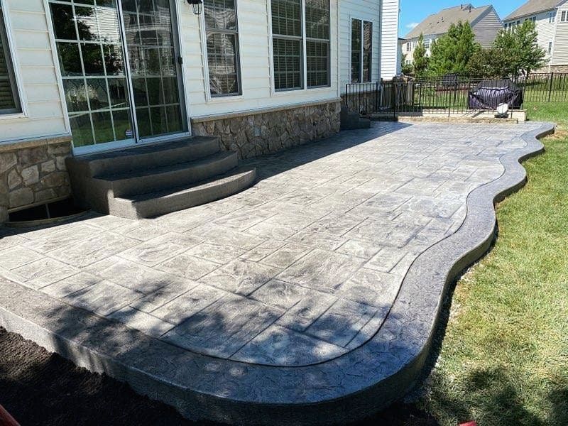 Curved stamped concrete walkway running alongside a home in Winchester VA