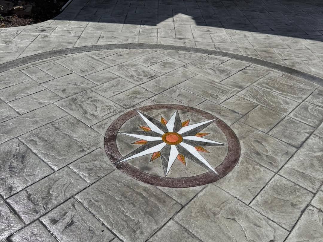 Compass medallion inlay set into a stamped concrete patio in Winchester VA