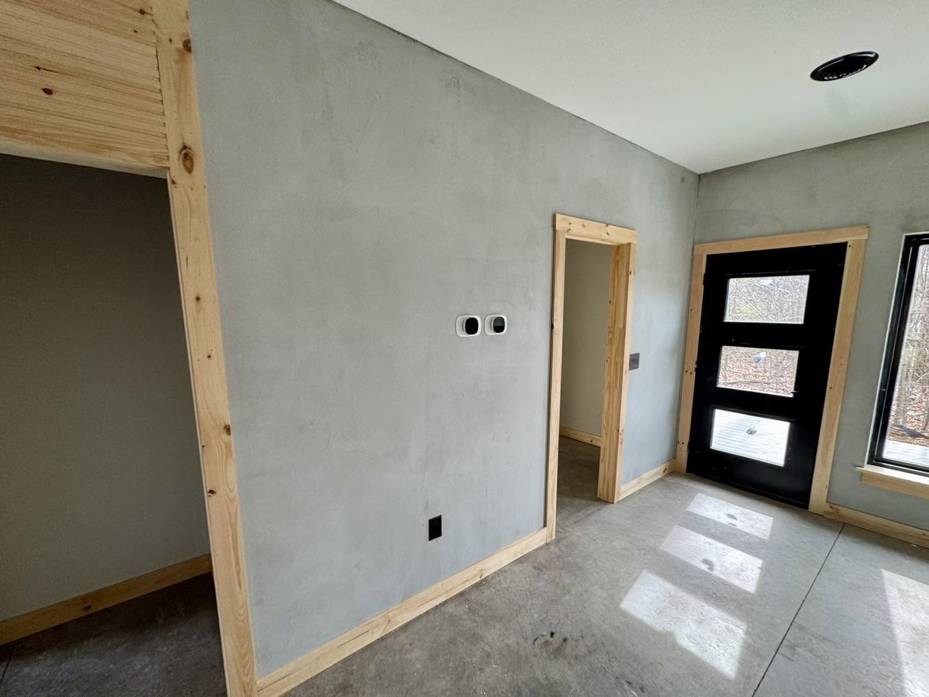 Cream microcement wall finish beside an interior doorway in Winchester VA