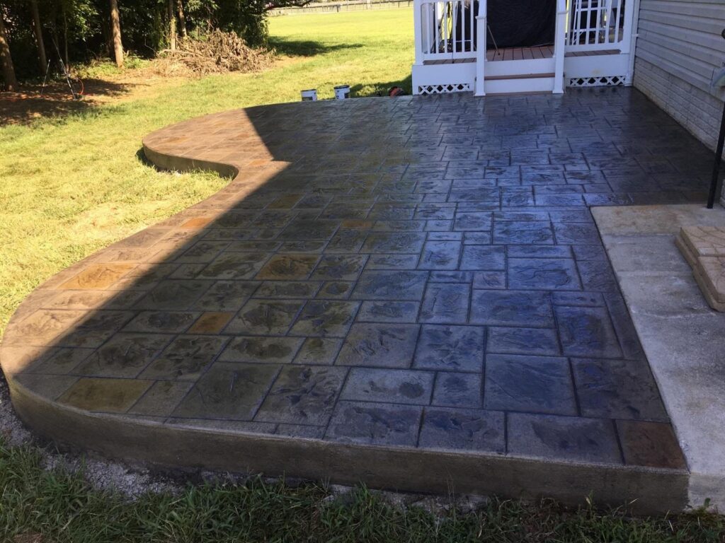 Large free form stamped concrete patio with a contrasting border in Winchester VA