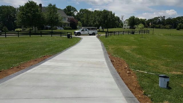 Long concrete driveway running out through an open field in Winchester VA